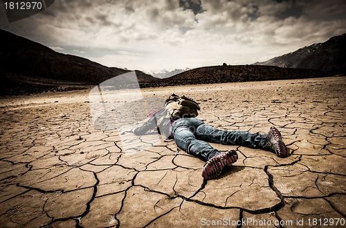 Image of person lays on the dried ground