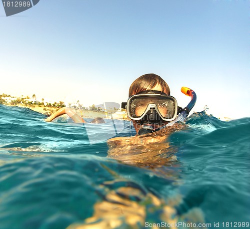 Image of boy floats in the sea