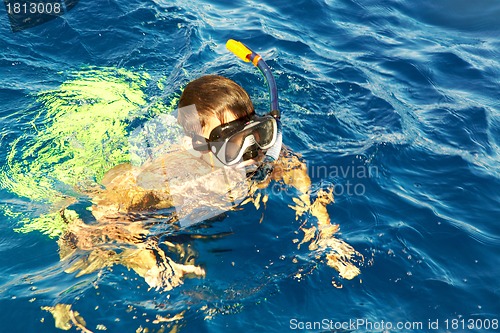 Image of boy floats in the sea