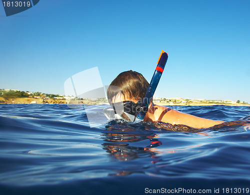 Image of boy floats under water in the sea