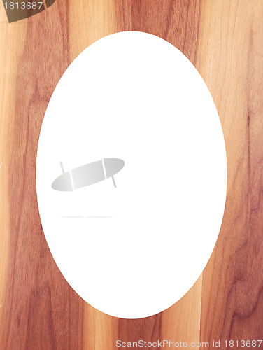 Image of Wooden floor background and white oval in center 