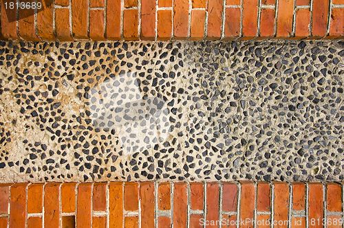 Image of Wall made of brick and concrete with little stones