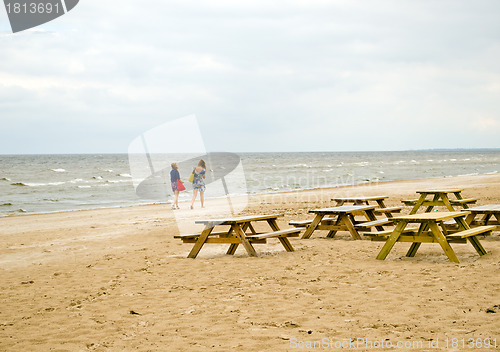 Image of Wooden benches table sea coast  teenage girls walk 