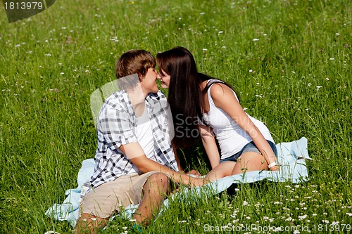 Image of young couple outdoor in summer on blanket in love