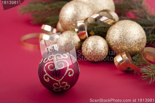 Image of beautiful golden christmas decoration on red background