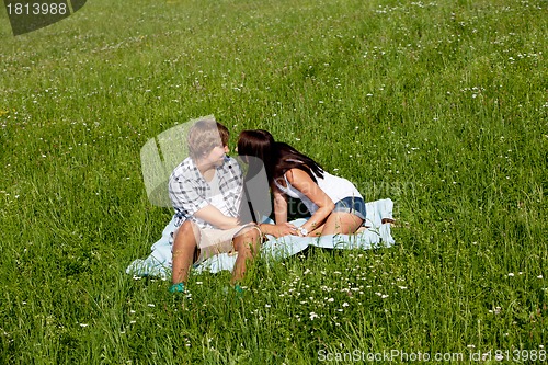 Image of young couple outdoor in summer on blanket in love