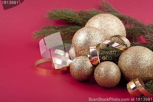 Image of beautiful golden christmas decoration on red background