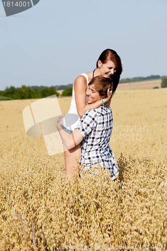 Image of happy couple in love outdoor in summer on field