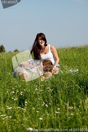 Image of young couple outdoor in summer on blanket in love
