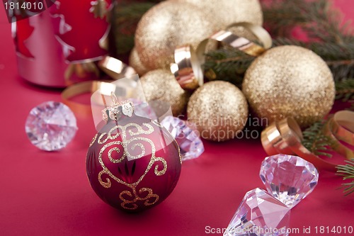 Image of beautiful golden christmas decoration on red background