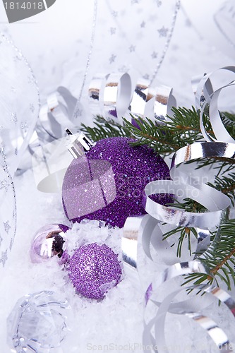 Image of beautiful christmas decoration in purple and silver on white snow