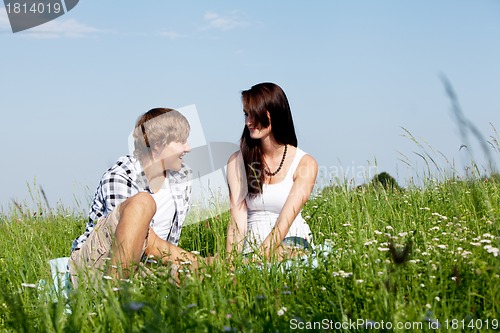 Image of young couple outdoor in summer on blanket in love