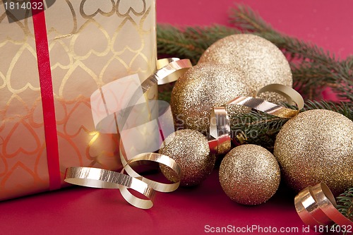 Image of beautiful golden christmas decoration on red background