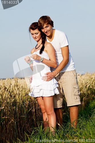 Image of happy couple in love outdoor in summer on field