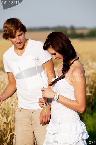 Image of happy couple in love outdoor in summer on field