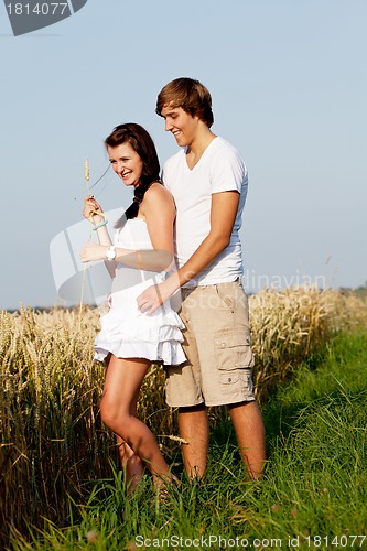 Image of happy couple in love outdoor in summer on field