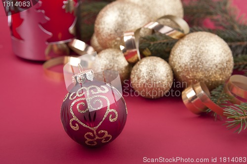 Image of beautiful golden christmas decoration on red background