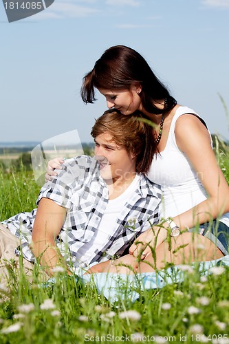 Image of young couple outdoor in summer on blanket in love