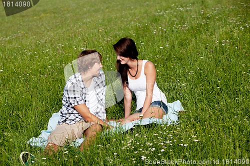 Image of young couple outdoor in summer on blanket in love