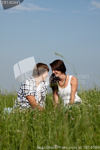 Image of young couple outdoor in summer on blanket in love