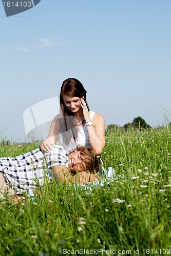 Image of young couple outdoor in summer on blanket in love