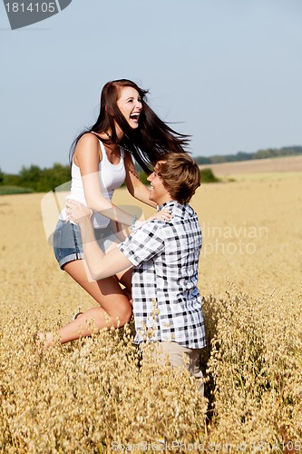 Image of happy couple in love outdoor in summer on field