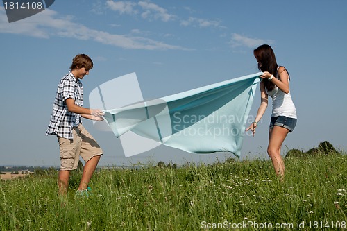 Image of young couple outdoor in summer on blanket in love