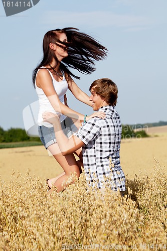Image of happy couple in love outdoor in summer on field