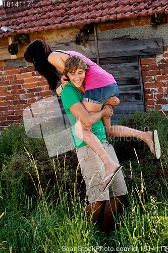 Image of young couple in love having fun in summer outdoor