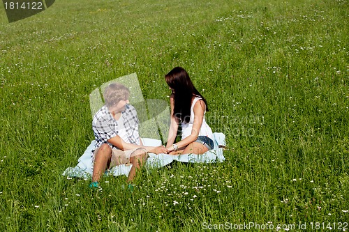 Image of young couple outdoor in summer on blanket in love