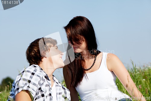 Image of young couple outdoor in summer on blanket in love