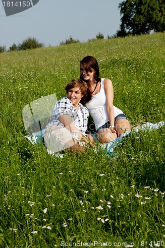 Image of young couple outdoor in summer on blanket in love