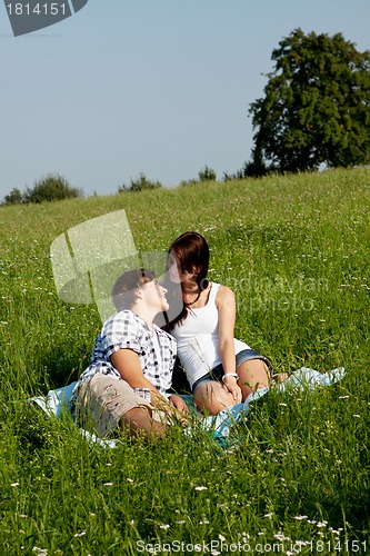 Image of young couple outdoor in summer on blanket in love