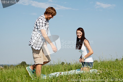 Image of young couple outdoor in summer on blanket in love