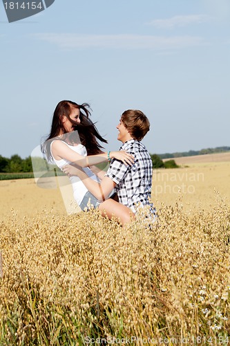 Image of happy couple in love outdoor in summer on field