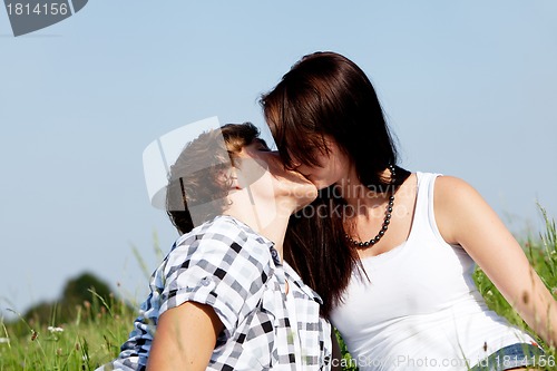 Image of young couple outdoor in summer on blanket in love