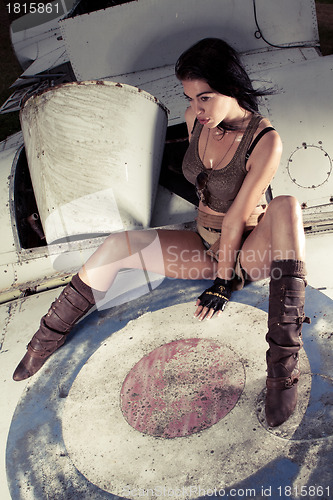 Image of Sexy woman on aeroplane fuselage