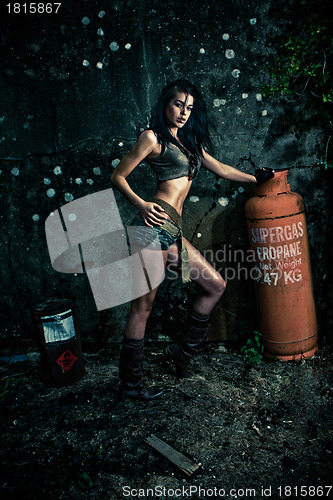 Image of Macho woman posing with gas bottle