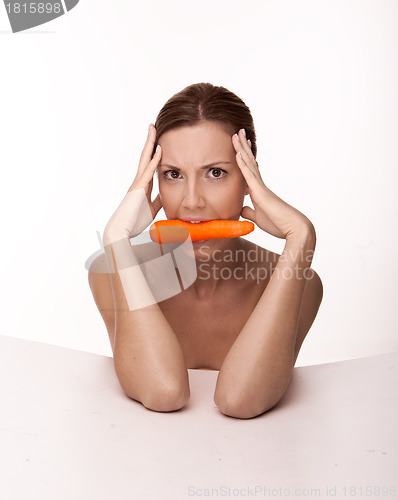 Image of Sexy brunette with a carrot
