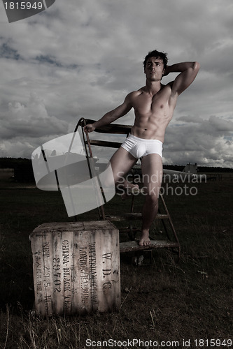 Image of Muscular man posing in briefs