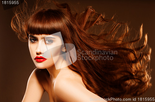 Image of Sultry redhead with hair flying