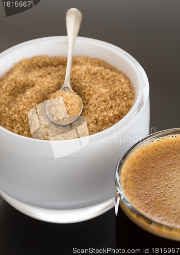 Image of Black coffee and froth in glass mug with sugar