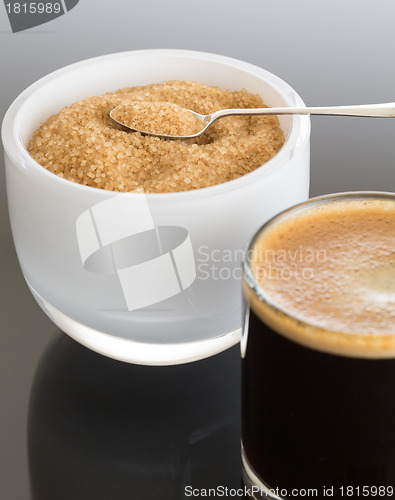 Image of Black coffee and froth in glass mug with sugar