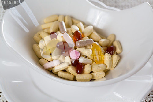 Image of Vitamins in bowl of tablets