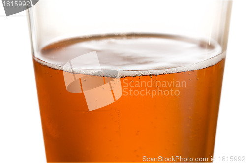 Image of Glass of cold golden beer with focus on edge