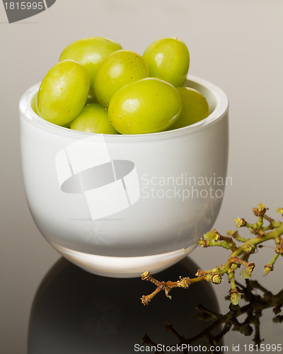 Image of White glass bowl full of green grapes