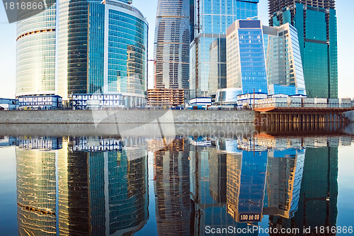 Image of Skyscrapers at sunset and reflection