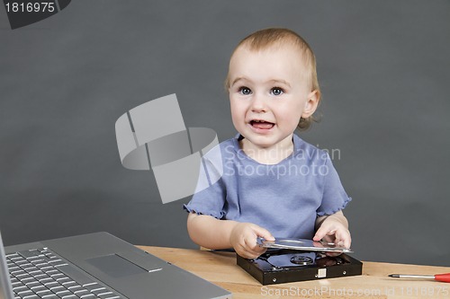 Image of child working at open hard drive