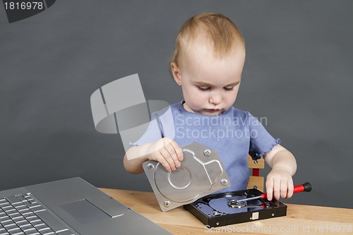 Image of child repairing open hard drive