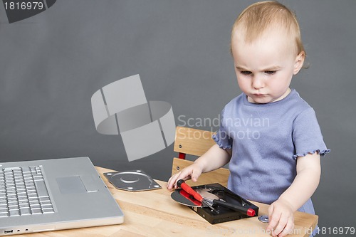 Image of child working at open hard drive